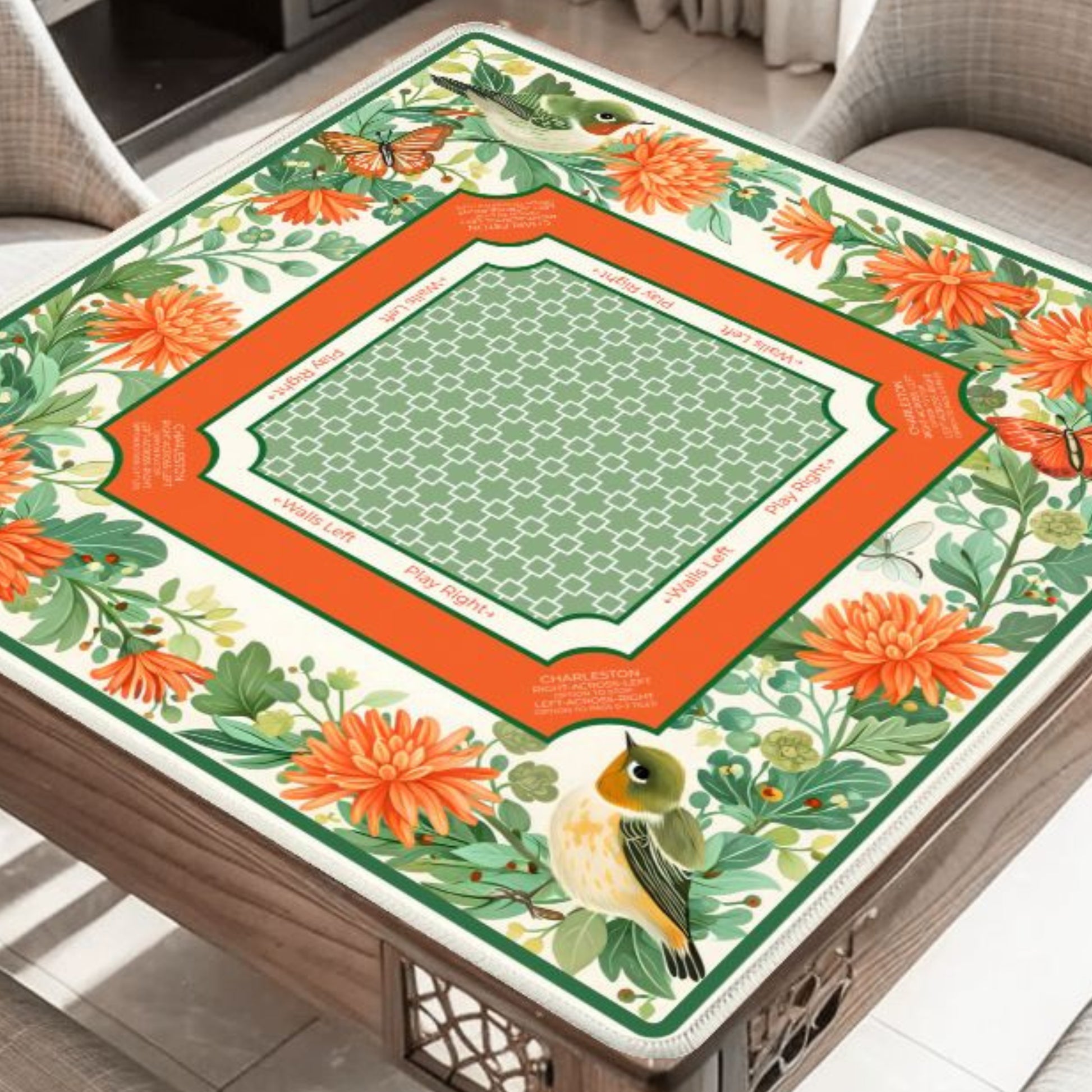Garden Aviary floral bird mahjong mat on table with orange flowers and butterflies