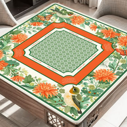 Garden Aviary floral bird mahjong mat on table with orange flowers and butterflies